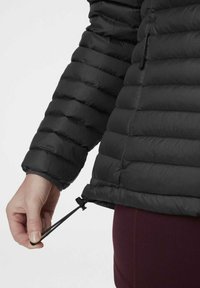 Zwarte pufferjack met horizontale stiksels, elastische manchetten en verstelbare trekkoordzoom. Gladde textuur met een lichtgewicht ontwerp.