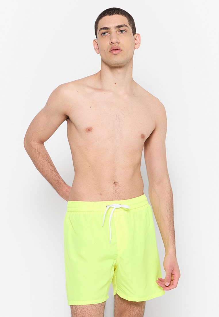 Neon gele zwemshorts van lichtgewicht stof, met een elastische tailleband en een koord, en een losse fit.