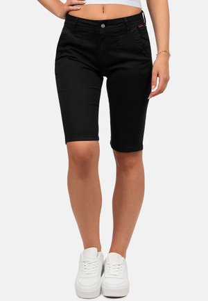 Bermuda shorts en denim noir avec une coupe ajustée, dotés d'une fermeture à bouton, de poches avant et d'une texture lisse et mate. Stylés avec des baskets blanches.