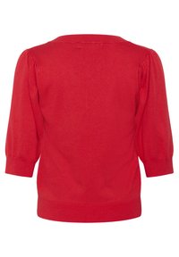 Punainen neulepusero, jossa on kolmanneksen pituiset hihat, pyöreä pääntie ja ribbireunus. Sujuva pinta, jossa on hienovaraisia ommel-yksityiskohtia.