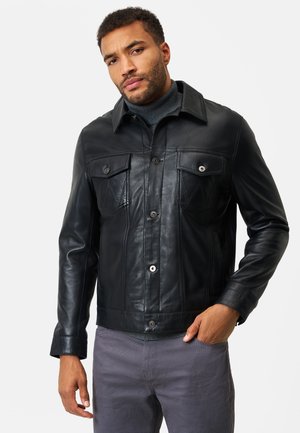 Black leather jacket with a classic collar, two chest pockets, and button closure. Features a smooth texture and tailored fit.