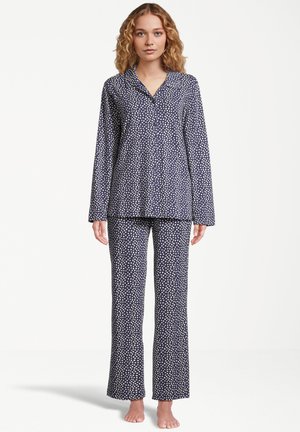 Marinblå pyjamasset med vita prickar, med lång ärm och raka byxor, tillverkat av mjukt tyg, med knäppning framtill.