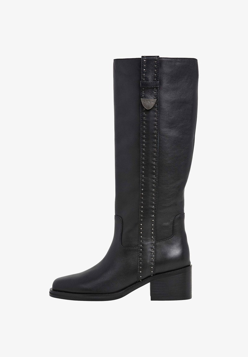 Bota de cuero negro hasta la rodilla con puntera rectangular, tacón cuadrado y acento decorativo de tachuelas a lo largo de la costura lateral. Textura suave.