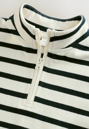 White and black striped pullover with a mock collar and half zipper, featuring a soft texture and prominent horizontal lines.