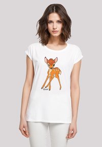 White cotton T-shirt featuring a graphic of a brown fawn with white spots. Short sleeves and a round neckline. "Bambi" text at the bottom.