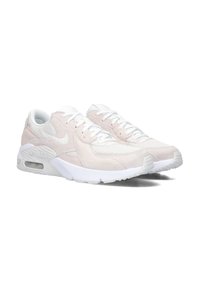 Zapatillas de ante y malla de color rosa claro con acentos blancos, que presentan una puntera redondeada y una amortiguación Air Max visible en la suela.