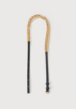 Chain and leather strap accessory featuring gold-colored metal links and a black leather strap with adjustable hardware and buckle details.