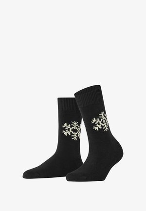 Czarne skarpetki z prążkowanymi mankietami mają kremowy wzór płatków śniegu z boku oraz dekoracyjny detal w postaci guzika. Wykonane z miękkiego materiału.
