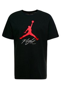 Svart bomull T-skjorte med en stor rød Jumpman-logo og "Flight"-tekst under i hvitt, med en klassisk rund hals.
