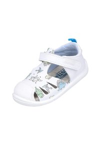 Zapato blanco para niños con patrones de dinosaurios en verde y azul, correa de Velcro, diseño de punta abierta y suela blanca texturizada.