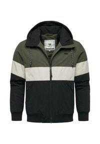 Giacca con zip a blocchi di colore in verde scuro, crema e nero, dotata di cappuccio, polsini elasticizzati e tasche laterali per funzionalità.