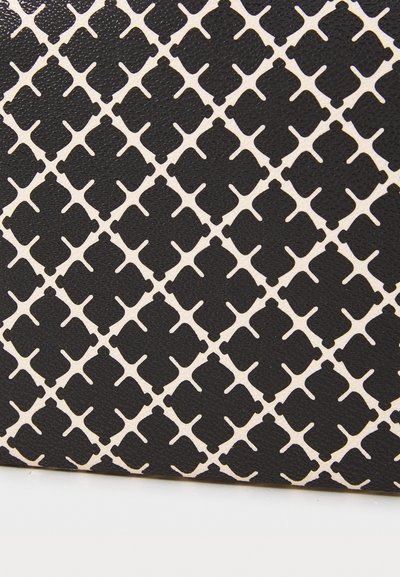 Black textured fabric featuring a white geometric pattern with diamond shapes and crosses, creating a striking contrast in design.