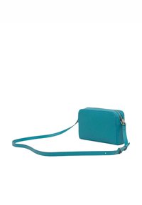 Sac bandoulière bleu sarcelle de forme rectangulaire, en matériau synthétique lisse, avec fermeture éclair. Dispose d'une bandoulière fine et réglable.
