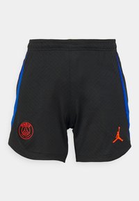 Musta urheiluhame, jossa on siniset sivuakkentit, punainen pyöreä Paris Saint-Germain -logo ja oranssi Jumpman-logo oikeassa alakulmassa.