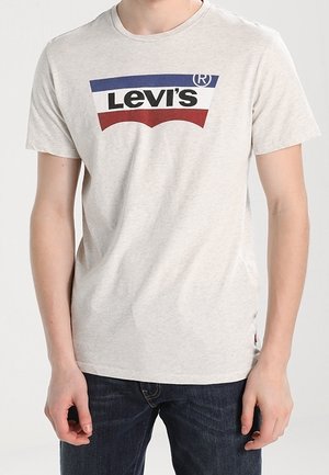 Light grey cotton T-shirt featuring a colored Levi's logo in blue, white, and red, round neck, and short sleeves. Worn with dark jeans.