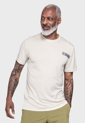 Beige short-sleeve athletic shirt with a smooth texture, featuring a grey accent panel and a logo on the front left side.