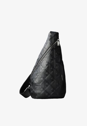 Sort læder skuldertaske prydet med geometriske mønstre og diagonal lynlås, med justerbar rem og Calvin Klein-logo.