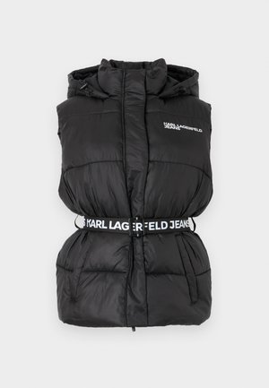 Svart jakkevest med høy krage, elastisk belte med logo, og sidelommer. Glatt, blank tekstur med quiltet mønster.