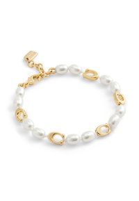 Bracelet en or comportant des perles blanches alternées et des accents en or. Design classique avec un fermoir en pince de homard et une petite étiquette.