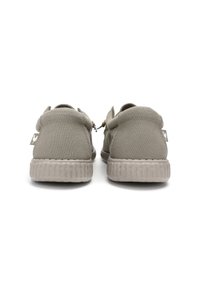 Grey canvas shoes with a textured rubber sole, round heel, and a pull tab. Features a subtle logo on the side and wooden toggle detail.