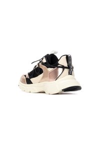 Zapatillas que combinan malla negra, detalles metálicos en oro rosa y acentos de cuero crema. Suela gruesa y cordones flexibles, con detalle de marca.