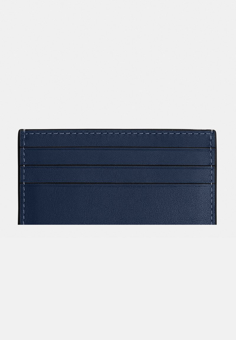Navy blue leather cardholder with three horizontal slots and visible white stitching along edges.