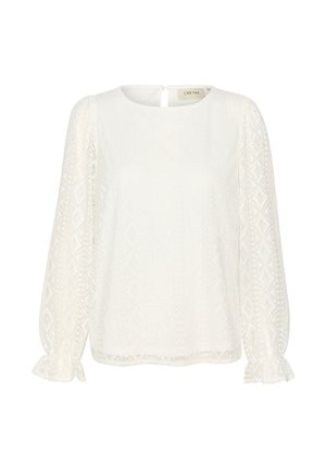 Camicia bianca con maniche lunghe e puff, scollo rotondo e motivi a diamante texture. Presenta un'apertura a chiave sulla schiena e polsini arricciati.