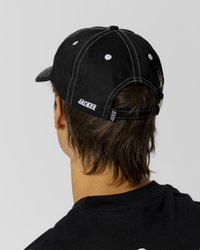 Black baseball cap with white stitching, adjustable strap, and embroidered logo on the side, viewed from behind against a neutral background.