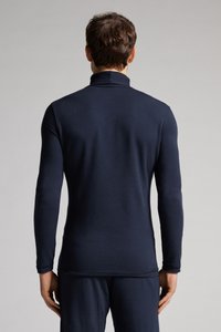 Granatowa bluzka z długim rękawem o wysokim kołnierzu, wykonana z gładkiego, elastycznego materiału. Dopasowany krój z minimalną ilością szwów i czystą sylwetką.