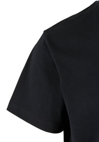 Sort bomulds t-shirt med rund hals og korte ærmer, tæt beskåret for at fremhæve ærme- og skulderområdet med synlige sømme.