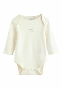 Cream long-sleeve baby bodysuit with small dotted pattern and a small embroidered bow on the chest, featuring snap buttons at the crotch.
