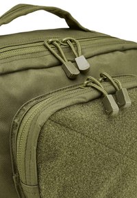 Olive green backpack with a textured surface, featuring dual zipper pulls and a reinforced handle on top.