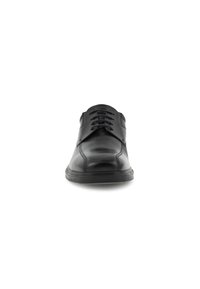 Chaussure habillée en cuir noir avec un bout arrondi, texture lisse, laçage à six oeillets et des coutures discrètes sur le dessus. Semelle en caoutchouc.