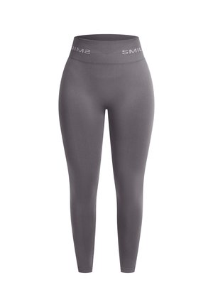 Graue nahtlose Leggings mit einem hohen Bund, der mit weißen Markentexten versehen ist. Hergestellt aus einem dehnbaren, glatten Stoff für optimalen Tragekomfort.