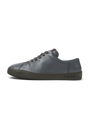 Gray leather sneaker with minimalistic design, rubber sole, rounded toe, and lace-up front. Features tonal stitching and a subtle logo.
