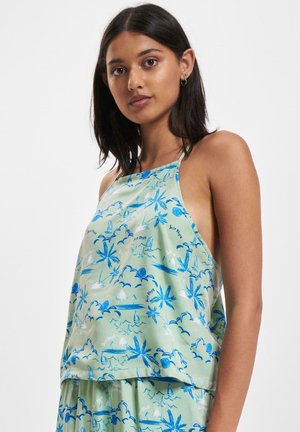 Top halter verde chiaro con stampa tropicale blu, caratterizzato da palme e nuvole. Tessuto liscio, taglio ampio e lati aperti per una buona traspirabilità.