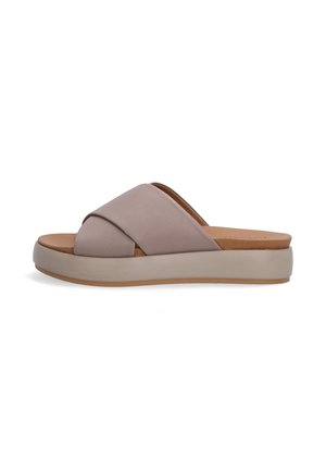 Light taupe slide sandals with faux leather upper. Crossed straps feature a smooth texture. Thick platform sole with a brown rubber base.
