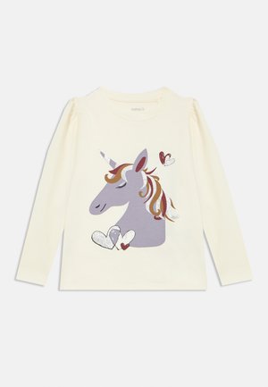 Long-sleeve cream shirt featuring a gray unicorn graphic with colorful mane and hearts, made from soft cotton. Detailed with glitter accents.