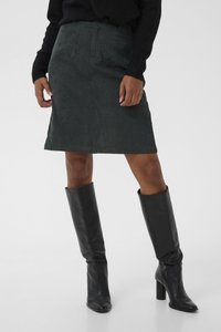 Dark green denim skirt with two back pockets, knee-length silhouette. Paired with tall black leather boots and a black sweater.
