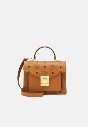 Tan leather handbag with gold hardware, featuring a flap closure, embossed logo pattern, and a detachable shoulder strap.