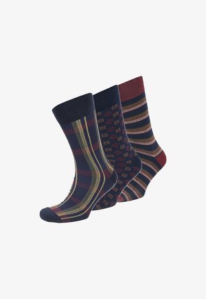 Drei Paare Baumwollsocken in verschiedenen Mustern: diagonale Streifen, geometrische Rauten und horizontale Linien. Die Farben umfassen Marineblau, kastanienbraun und Gold.