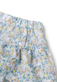 Falda con cintura elástica en tejido azul claro que presenta un estampado de hojas multicolores. La textura es suave y cuenta con detalles fruncidos en la cintura.