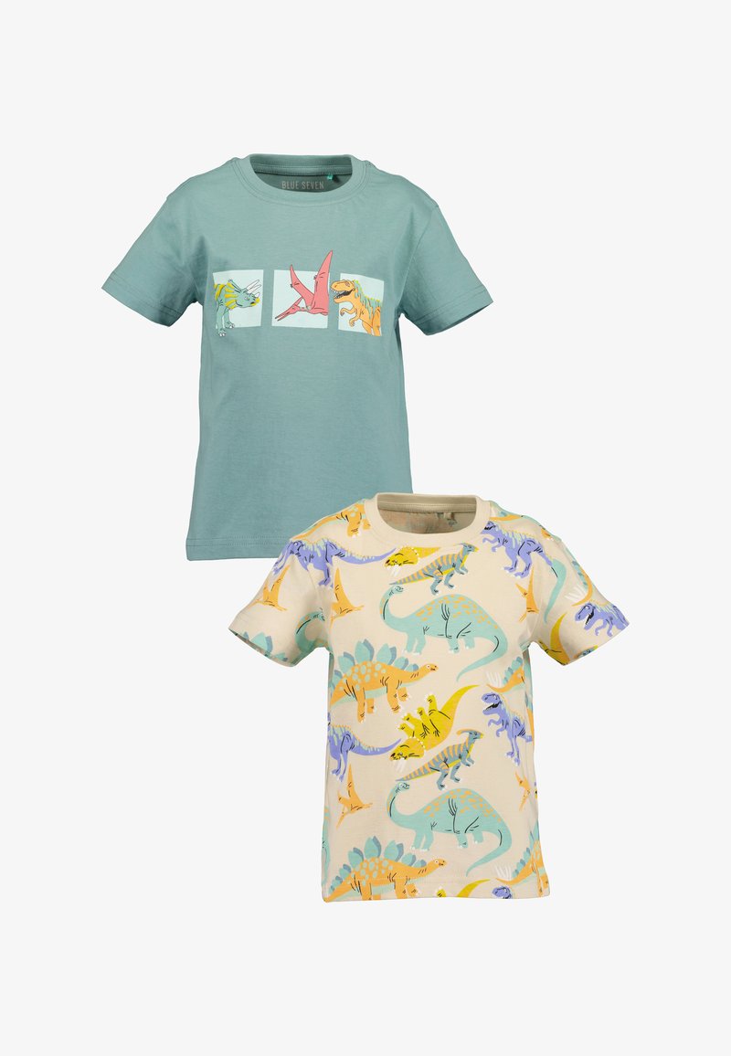 Deux T-shirts à manches courtes : un vert menthe avec des graphiques de dinosaures ; un crème avec des motifs de dinosaures colorés. Coton doux, coupe décontractée.