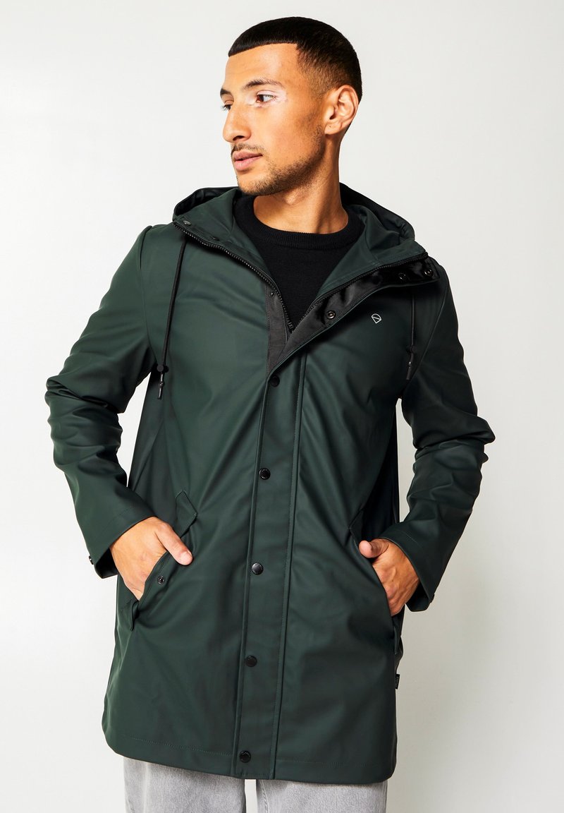 Green waterproof jacket with a hood, featuring a zippered front, black accents, and side pockets. Smooth texture with a modern silhouette.