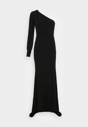 Robe noire à manches longues avec un design asymétrique à une épaule. Texture lisse, coupe ajustée et fente haute sur un côté.
