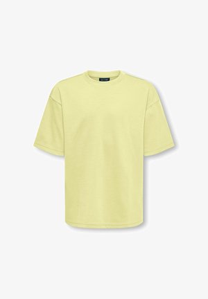 Lysegul kortærmet oversized bomulds-T-shirt med rund hals, lagt fladt på hvid baggrund.