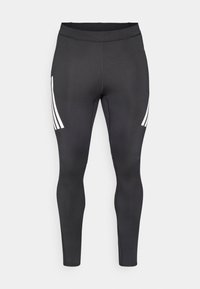 Svarta leggings med slät textur, med tre vita ränder på sidan. Hög midja för komfort och passform.