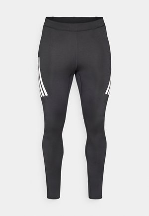 Melnas legingas ar gludu tekstūru, sānos ar trim baltām svītrām. Augsta jostas daļa ērtumam un piemērotībai.