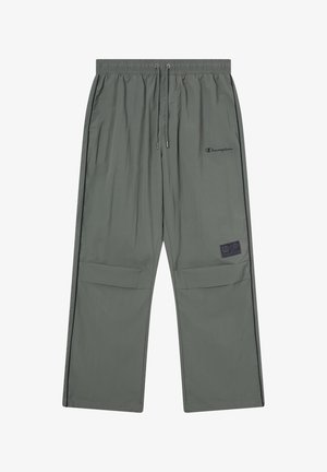 Pantalones ligeros de color verde oliva con cintura elástica, detalle de cordón, bolsillos laterales, costuras negras y un parche con logo.