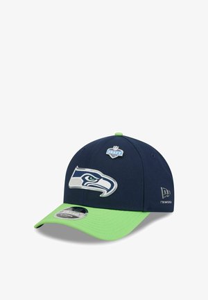 Seattle Seahawks navy and neon green baseball cap with team logo and NFL Draft 2023 emblem on front, New Era logo on side.
